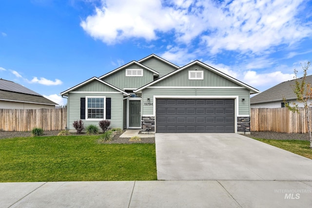 craftsman house with fence, board and batten siding, an attached garage, and driveway