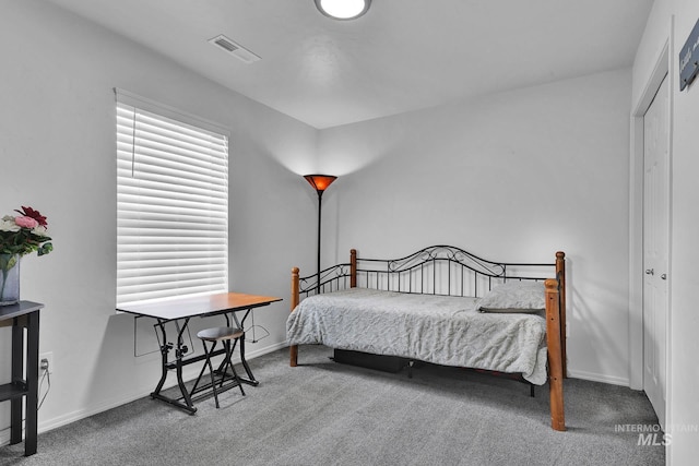 bedroom featuring baseboards, carpet flooring, and visible vents