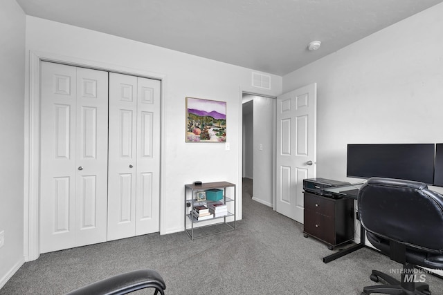 carpeted home office featuring visible vents and baseboards