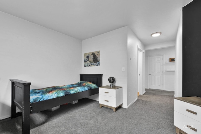 carpeted bedroom with baseboards and a fireplace