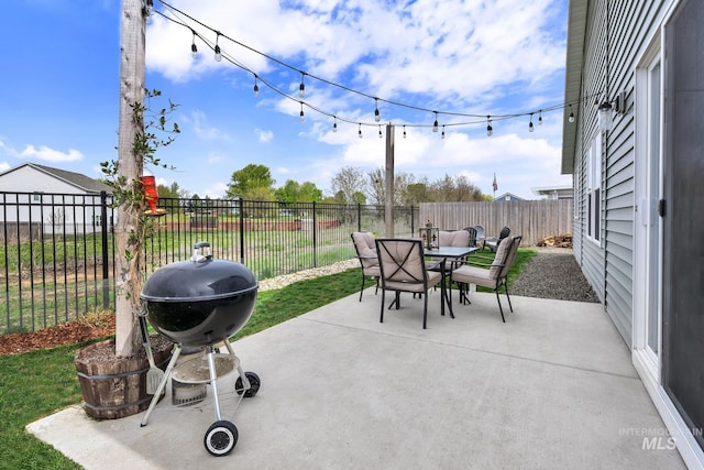 view of patio featuring a fenced backyard, outdoor dining space, and a grill