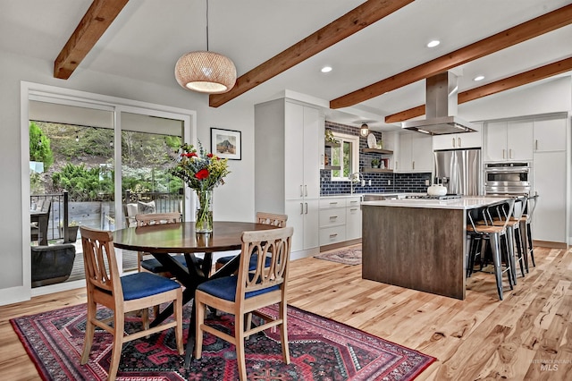 dining area featuring recessed lighting, light wood finished floors, and lofted ceiling with beams