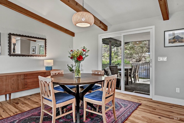 dining space with wood finished floors, baseboards, and beam ceiling