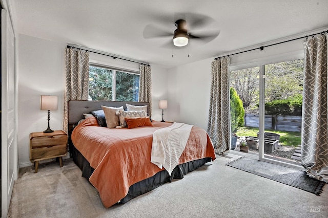 bedroom featuring light carpet, access to exterior, and ceiling fan