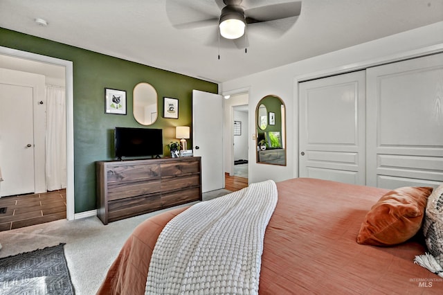 bedroom with carpet flooring, a closet, and ceiling fan