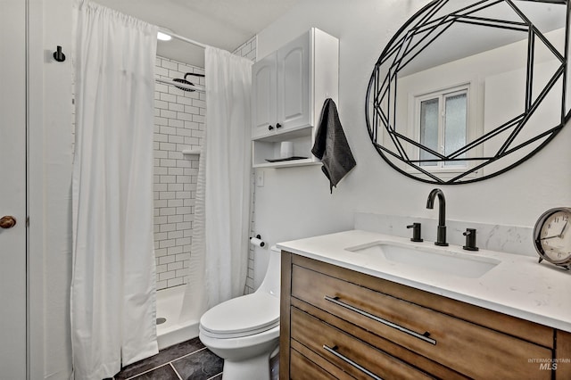 bathroom with a shower stall, tile patterned flooring, vanity, and toilet