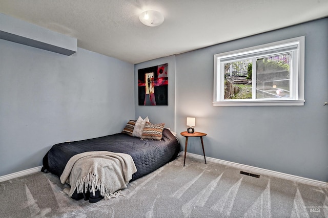 bedroom featuring visible vents, baseboards, and carpet flooring