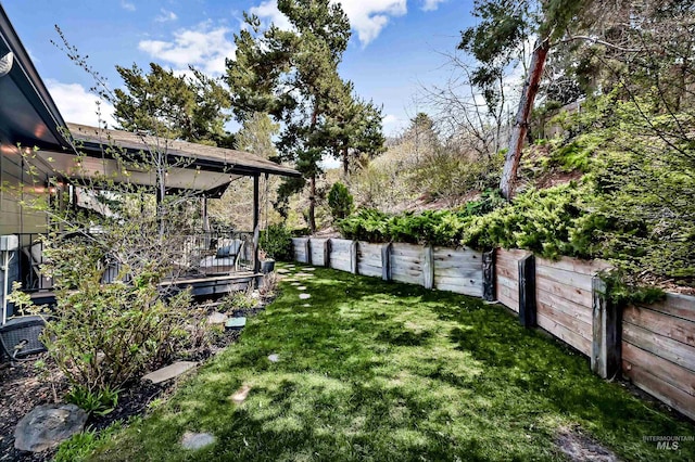 view of yard with a fenced backyard and a deck