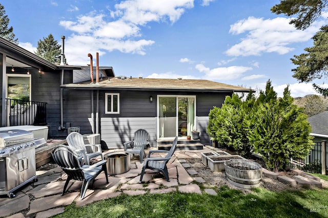 view of patio / terrace with entry steps, a vegetable garden, a fire pit, and area for grilling