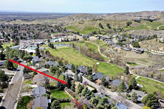 aerial view featuring a water view, view of golf course, and a residential view