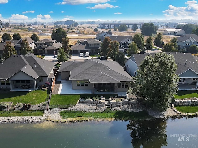 bird's eye view featuring a water view and a residential view