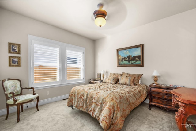 bedroom with baseboards and light colored carpet