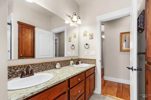 full bath with double vanity, backsplash, and a sink