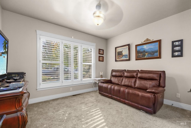 living area featuring carpet and baseboards