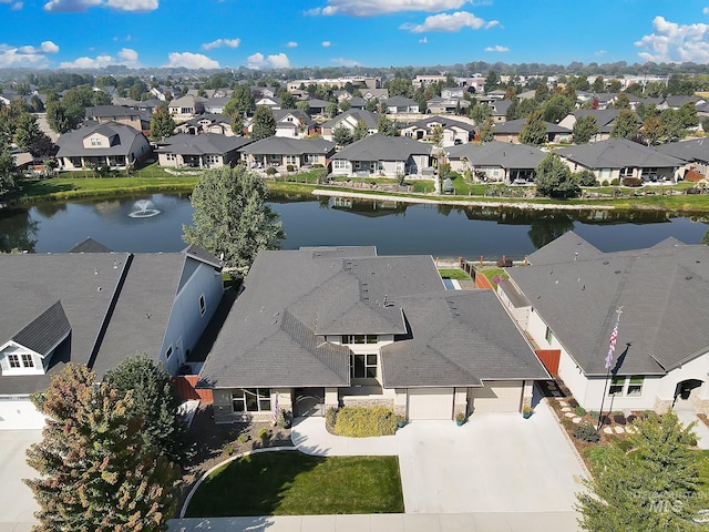 bird's eye view featuring a water view and a residential view