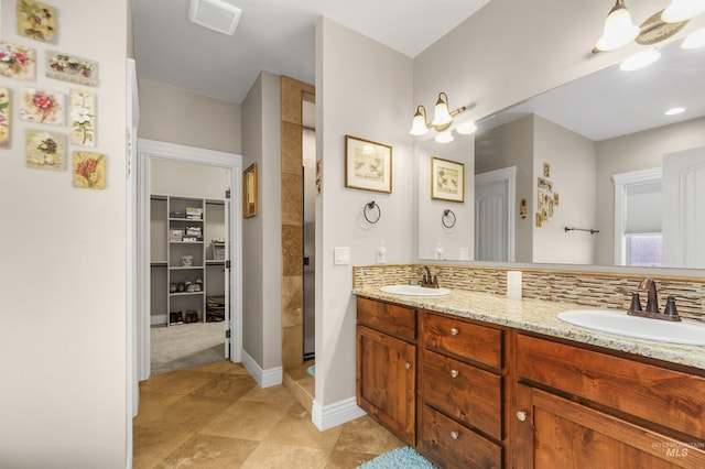 full bathroom with double vanity, a sink, visible vents, and decorative backsplash