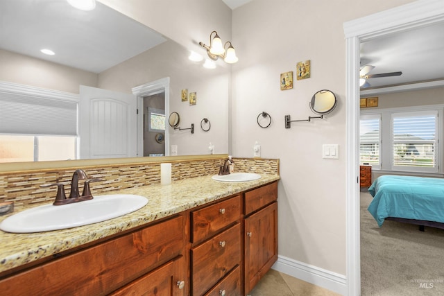 full bath featuring baseboards, a sink, ensuite bath, and decorative backsplash