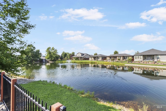 property view of water featuring a residential view and fence