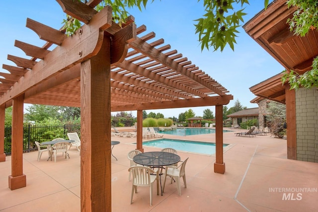 community pool featuring a patio area, fence, and a pergola