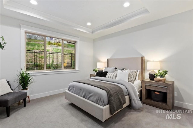 bedroom with recessed lighting, baseboards, a raised ceiling, and light colored carpet