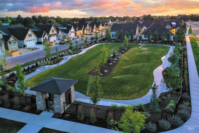 aerial view at dusk featuring a residential view