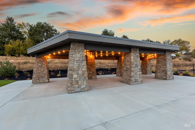 patio terrace at dusk with a gazebo and fence