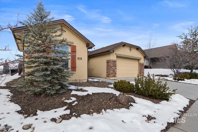 view of front of property with a garage, stone siding, and stucco siding