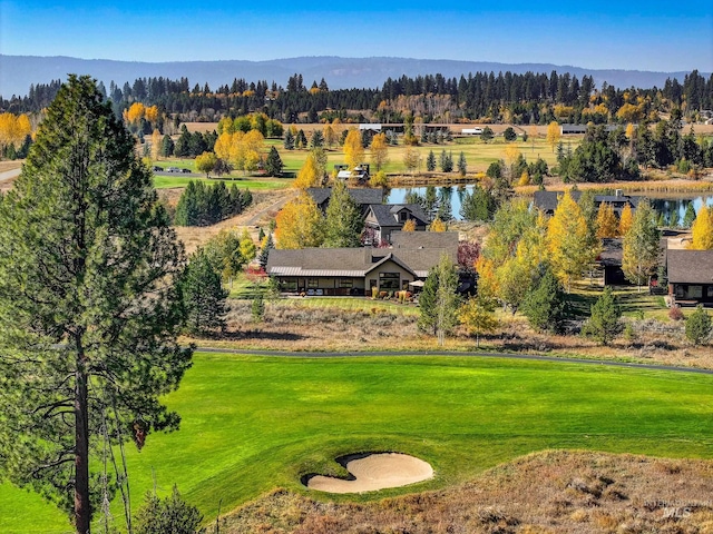 birds eye view of property with a water and mountain view