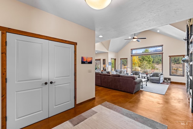 living room with ceiling fan and vaulted ceiling