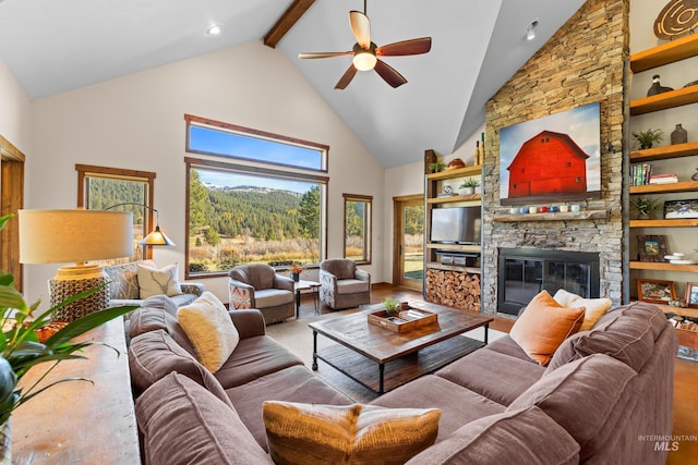 living room featuring high vaulted ceiling, a stone fireplace, ceiling fan, beamed ceiling, and wood-type flooring