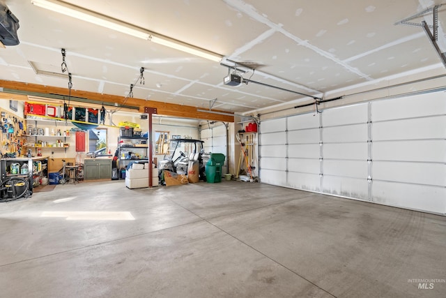 garage with a workshop area and a garage door opener