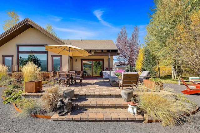 rear view of property featuring outdoor lounge area and a patio area