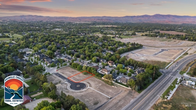 aerial view at dusk featuring a mountain view