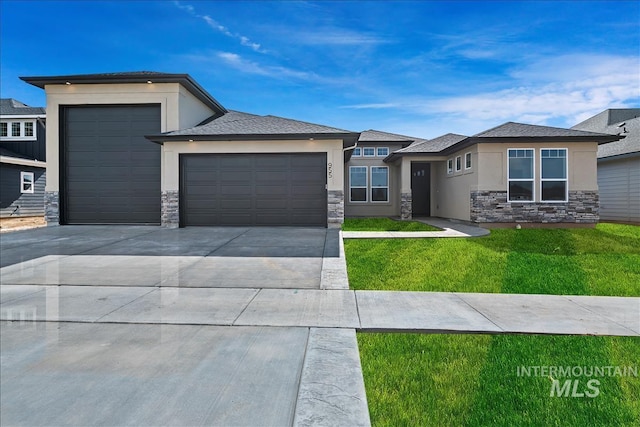 prairie-style house with a front lawn and a garage