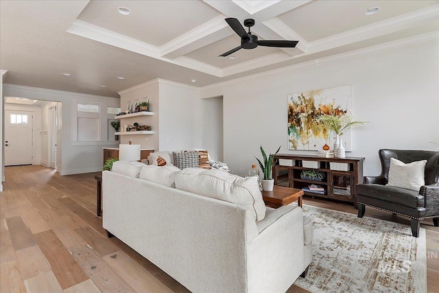 living room featuring coffered ceiling, crown molding, light hardwood / wood-style flooring, ceiling fan, and beamed ceiling