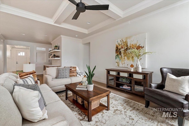 living room featuring wood-type flooring, beam ceiling, ornamental molding, and coffered ceiling