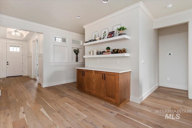 bar with light wood-type flooring and ornamental molding