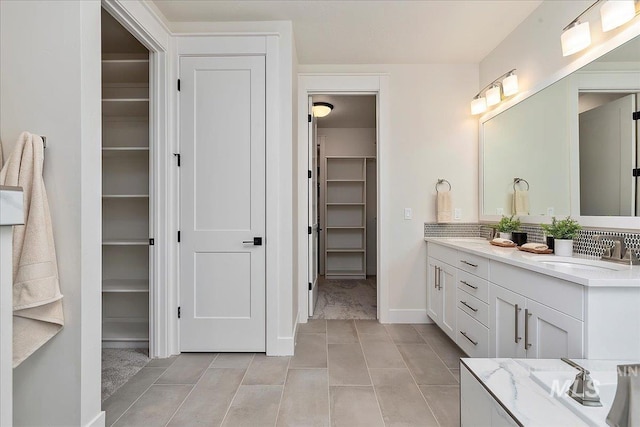 bathroom with tile patterned floors and vanity