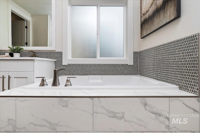 bathroom featuring vanity and a bathing tub