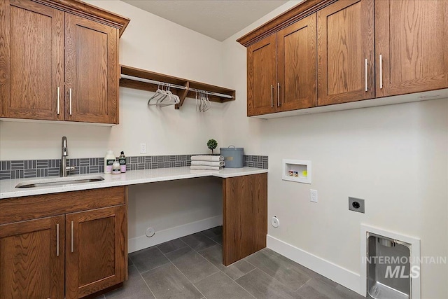 laundry area with sink, cabinets, washer hookup, hookup for an electric dryer, and hookup for a gas dryer