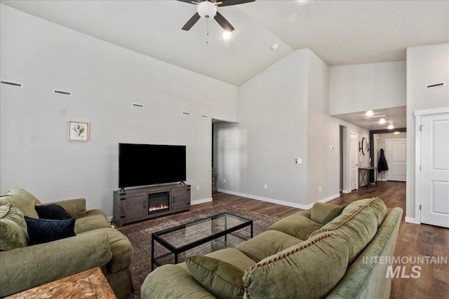 living room with ceiling fan, dark wood-type flooring, and high vaulted ceiling