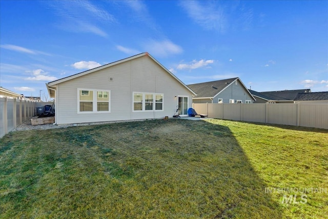 rear view of property featuring a lawn