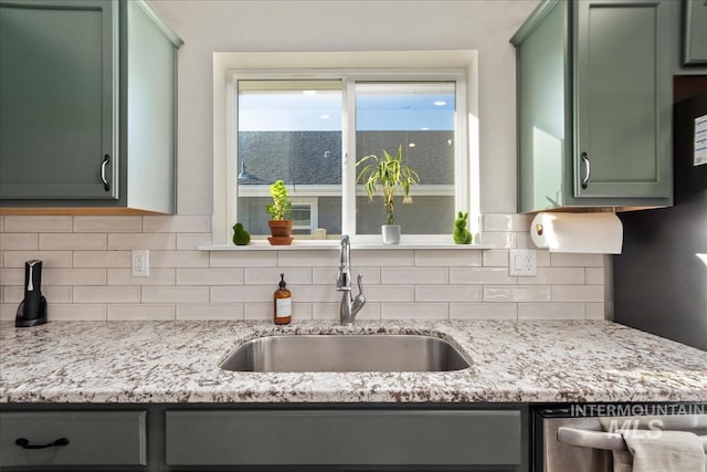 kitchen with tasteful backsplash, sink, and green cabinets