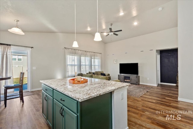 kitchen with lofted ceiling, hanging light fixtures, dark hardwood / wood-style flooring, and a center island