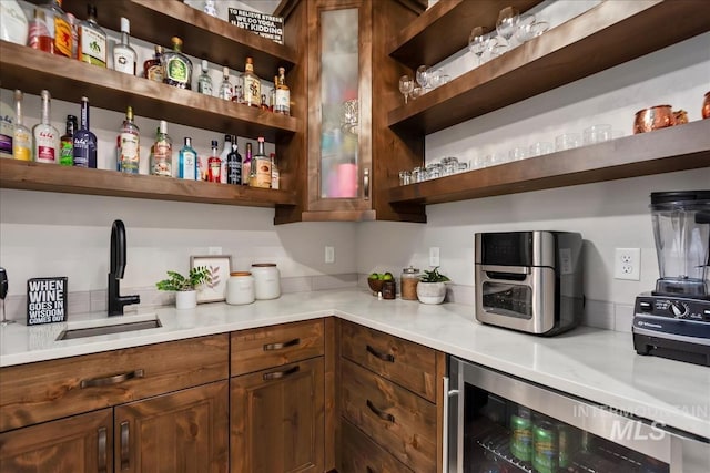 pantry with a sink and beverage cooler