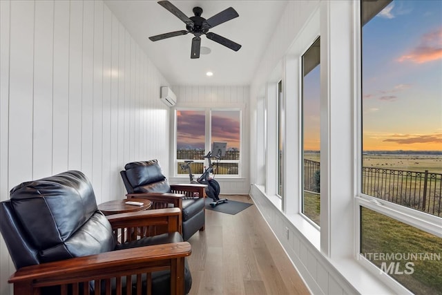 interior space with ceiling fan and a wall mounted AC