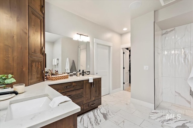 full bathroom featuring marble finish floor, a walk in shower, recessed lighting, baseboards, and vanity