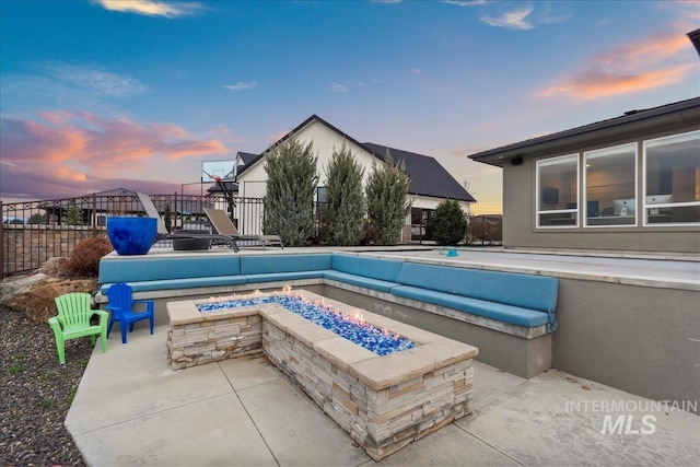 view of pool with a patio area, an outdoor fire pit, and fence