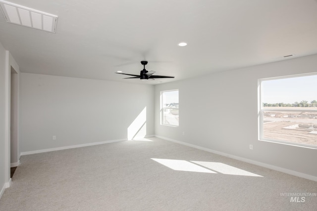 empty room featuring recessed lighting, baseboards, a ceiling fan, and light colored carpet