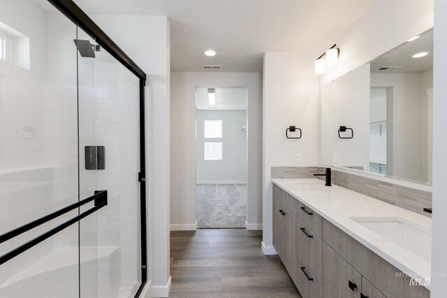 2735 N Silver Wolf Ave, Star, ID 83669 - bathroom with a sink, baseboards, a shower stall, and double vanity